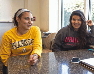 Freshman chemistry major Katie Sampson and junior exercise science major Savannah Bowen discuss the improvements in the Lumbee Native American community last Thursday in Trivette Dining Hall. Photo by Kelly Walker  |  The Appalachian