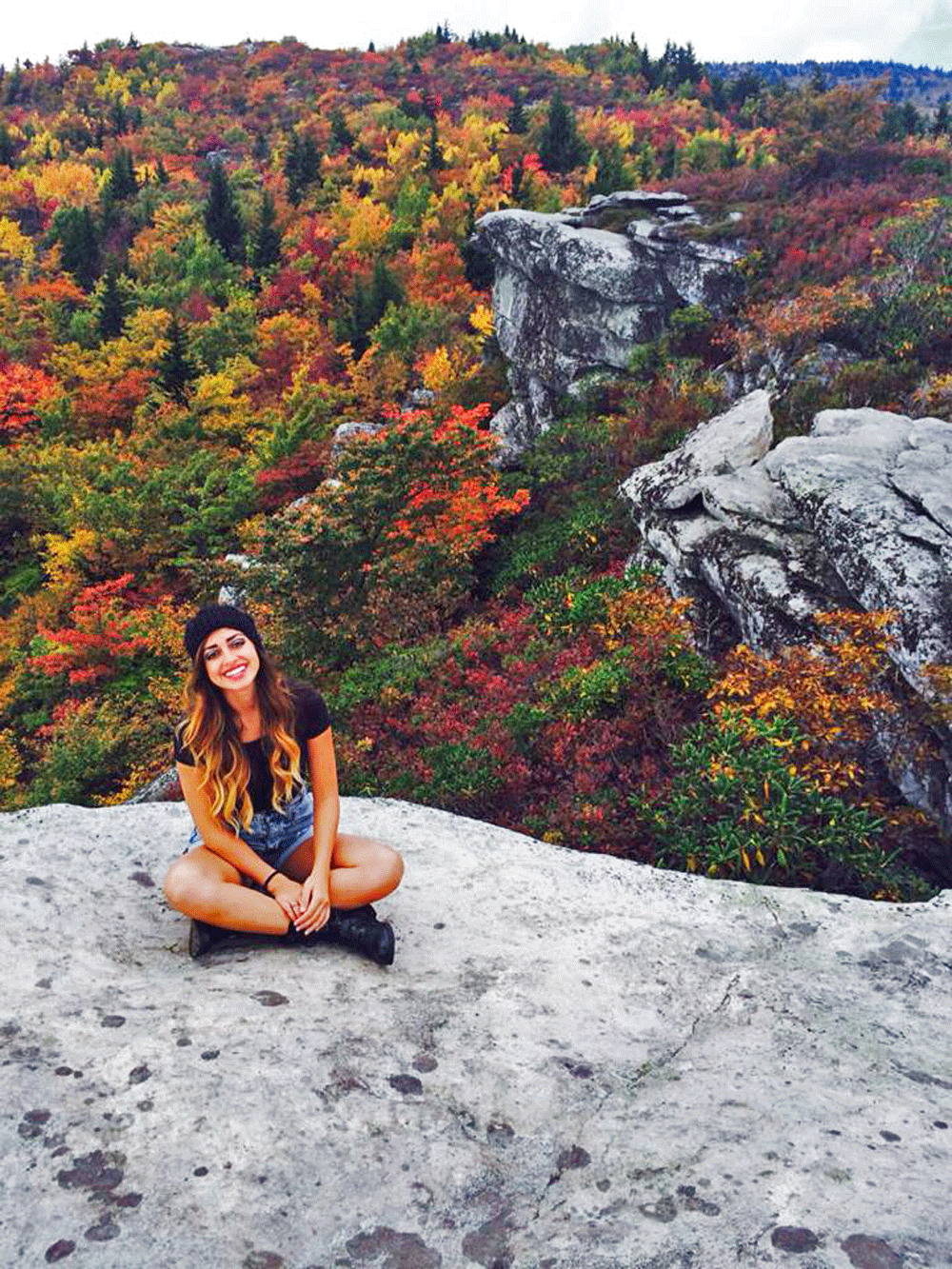 Sophomore+biology+major+Adrianna+Castro+sits+on+a+cliff+at+the+top+of+Rough+Ridge.+The+hike+at+Rough+Ridge+is+a+favorite+among+several+Appalachian+State+University+students.+Photo+courtesy+of+Nicholas+Lisle