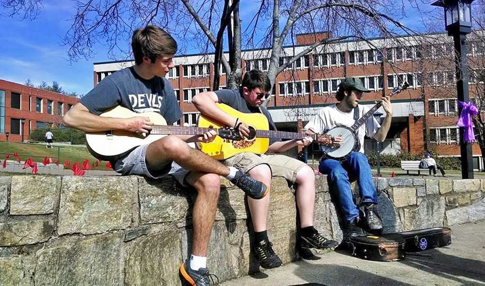 Sophomore physics major Addison Dorn (left), social studies education major A.J. Bennett (center) and evolution and environmental biology major Ben Banick play music on Sanford Mall. Photo Courtesy Kevyn Cress