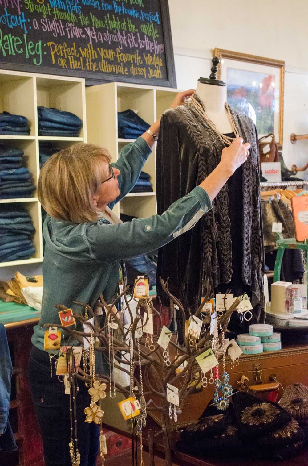 Lililu on King Street owner Libbi Henley dresses a mannequin in her boutique Nov. 11. Photo by Morgan Cook  |  The Appalachian