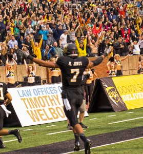 Junior wide receiver Malachi Jones pumps up the crowd at the homecoming game against Liberty University at Kidd Brewer Stadium. Photo by Paul Heckert  |  The Appalachian