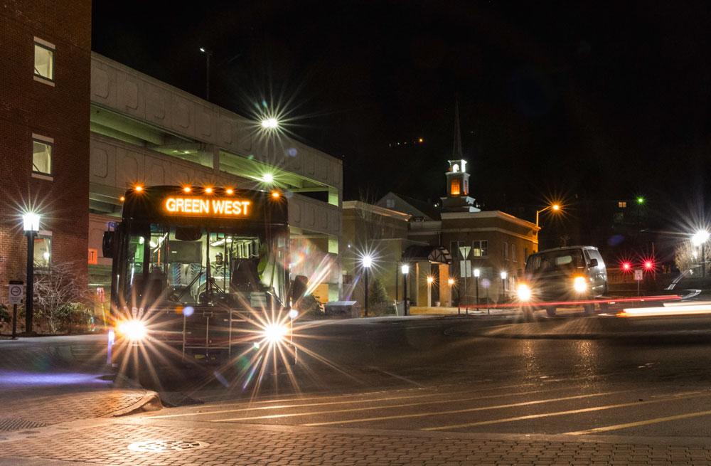 AppalCART’s Green Route and a Safe Ride van wait for passengers Wednesday evening in the library circle. Safe Ride’s hours have extended to 3 a.m. and AppalCART has extended Gold Route hours to 11:50 p.m. and added a tripper bus to the Purple route. Photo by Paul Heckert  |  The Appalachian