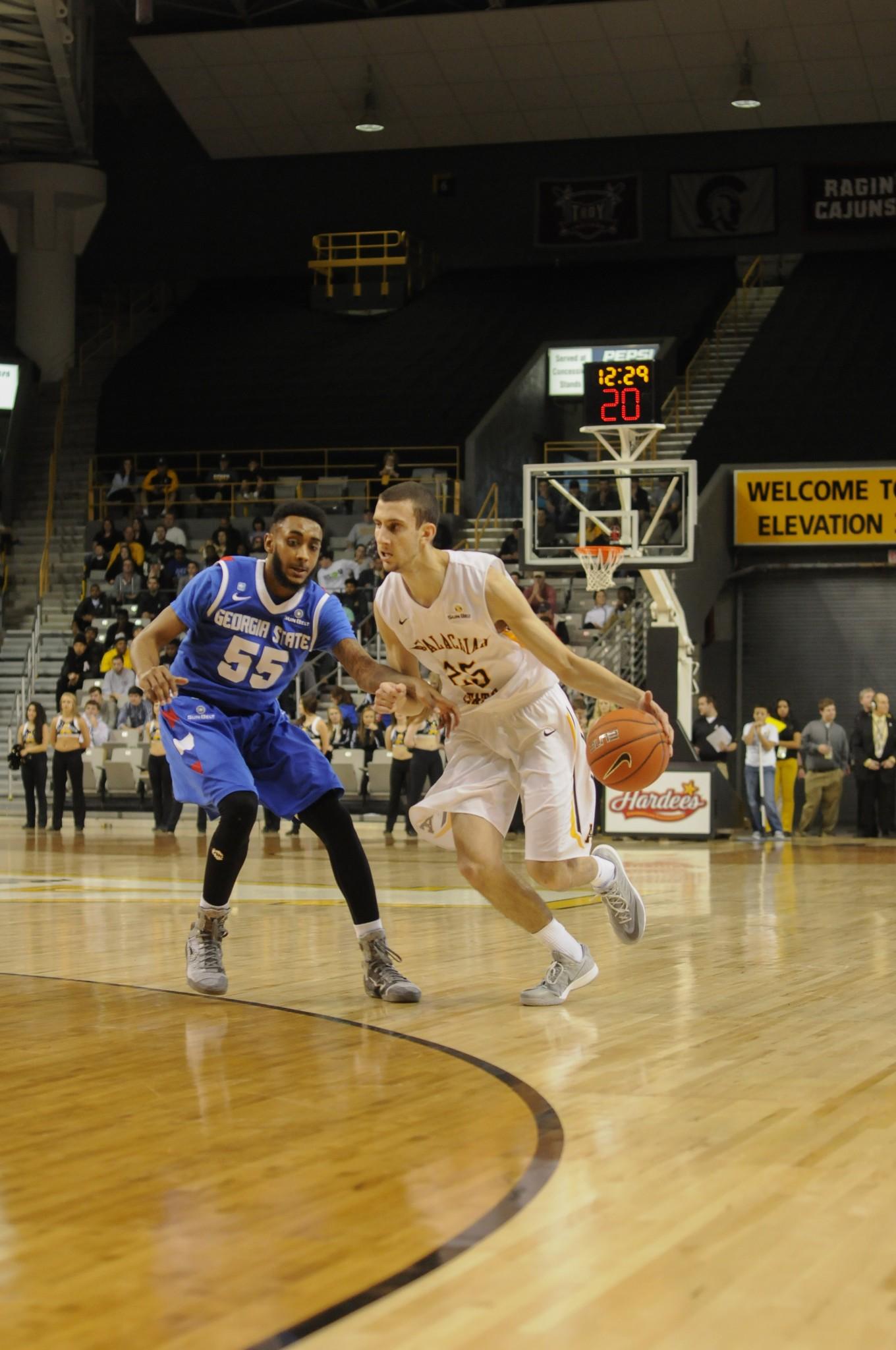 Freshman guard Jake Babic dribbles around a defender in a game against Georgia State. Babic is tied for fifth on the team in scoring. Photo by Justin Perry  |  The Appalachian