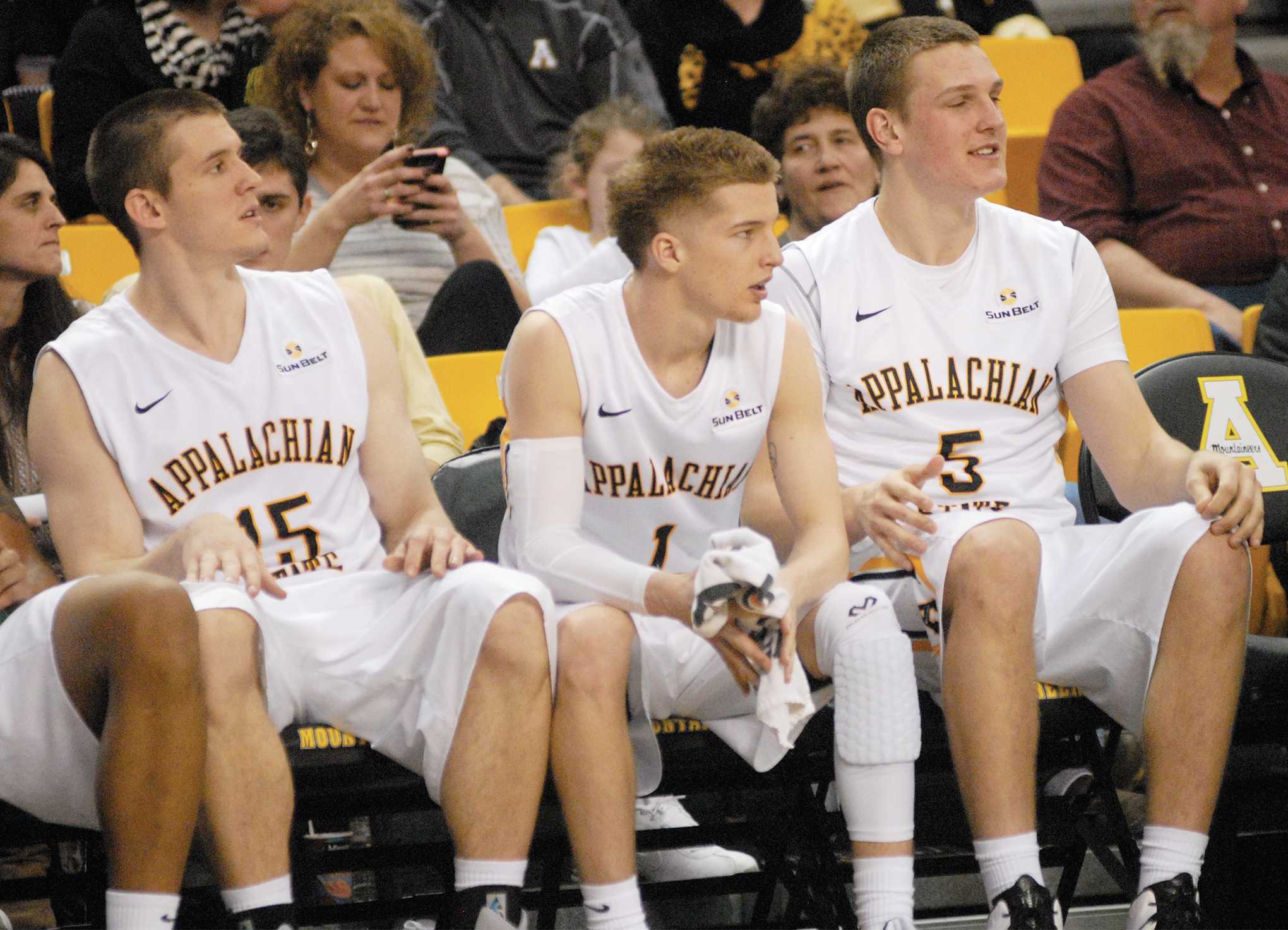 (Left to right) Fifth-year senior forward Tommy Spagnolo, freshman guard Landon Goesling and freshman forward Griffin Kinney watch the action from the bench against Troy. Photo by Corey Spiers  |  The Appalachian
