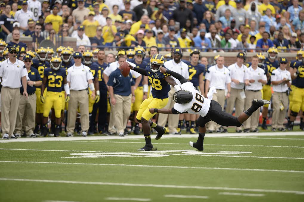 Junior linebacker John Law attempts to bring down Michigans senior quarterback, Devin Gardner in a game last season. In addition to the return of Law, the Mountaineers are hopeful of a strong, veteran defense next season.