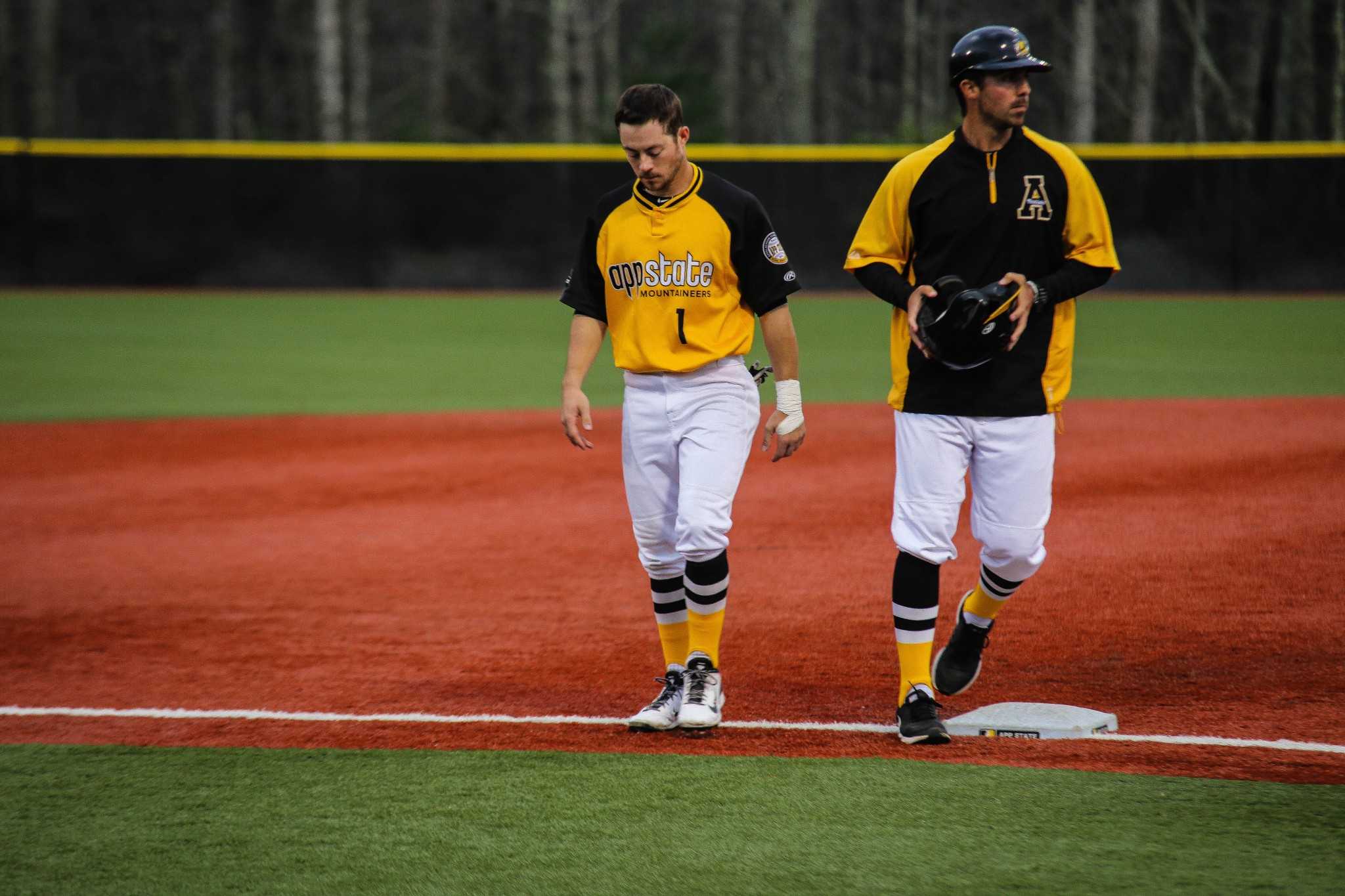 Junior outfielder Brandon Burris (left) walks off the field during App States series opener against Georgia State. The Mountaineers had multiple defensive errors that resulted in a 4-3 loss in 12 innings. Photo: Gerrit Van Genderen | The Appalachian
