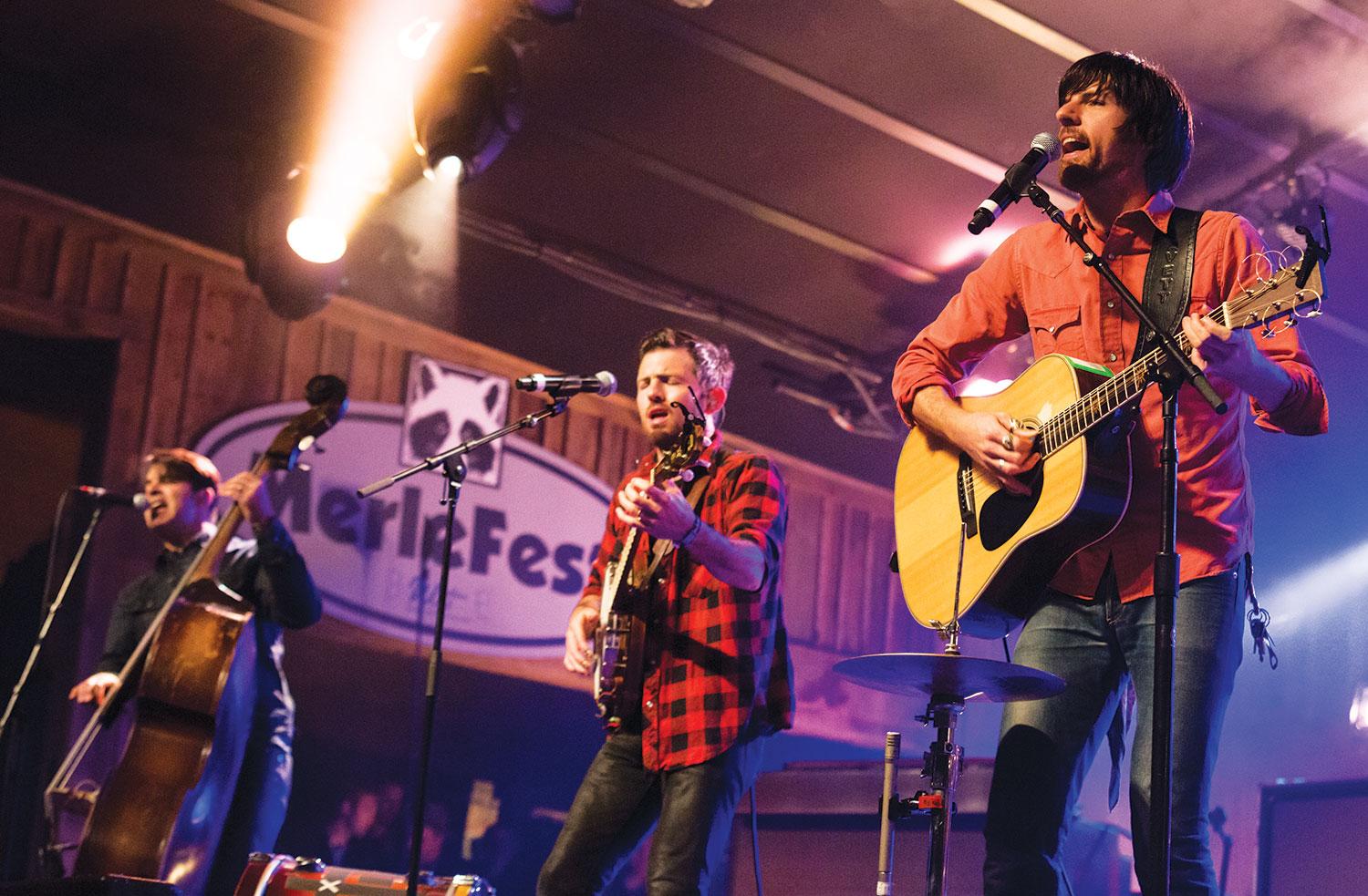 Avett Brothers frontmen Bob Crawford (left), Scott Avett and Seth Avett perform on The Doc and Merle Watson Stage on Saturday night at MerleFest, an annual bluegrass festival that takes place on the campus of Wilkes Community College. Photo by Paul Heckert  |  The Appalachian