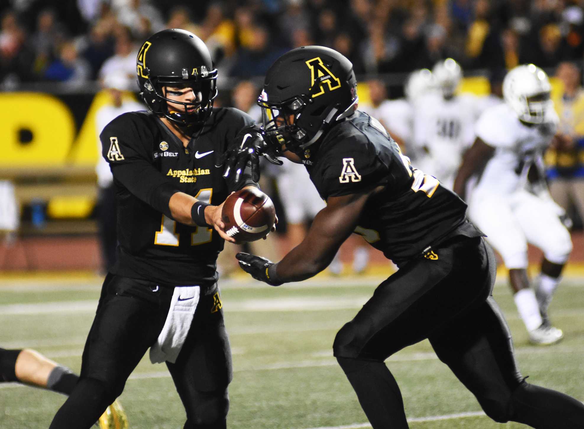 Quarterback Taylor Lamb hands the ball off during a game against Georgia Southern earlier this season. The Mountaineers improved to 9-2 Saturday following a 28-7 victory of Louisiana Lafayette.