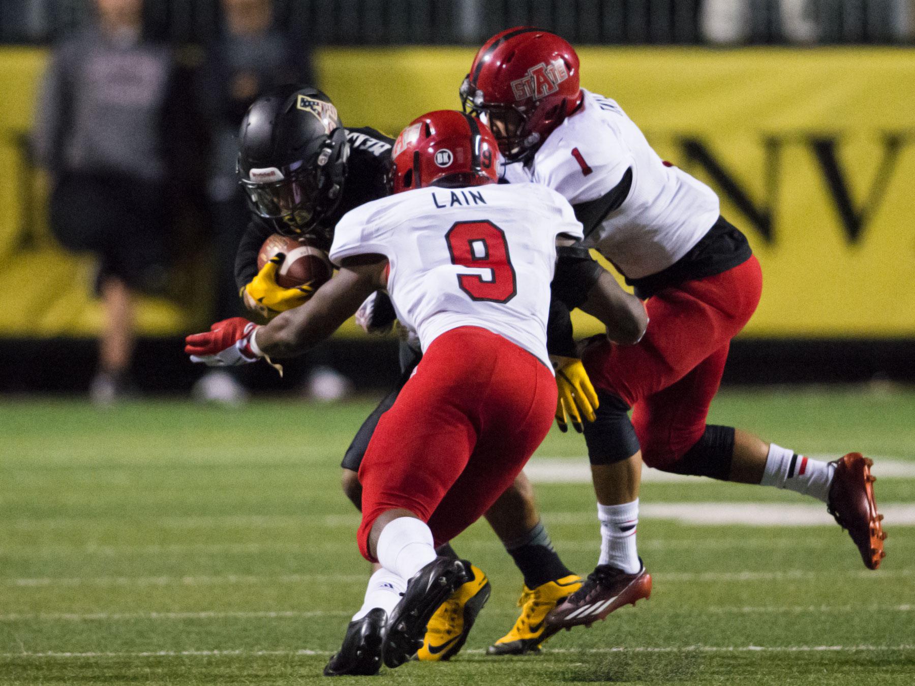 Wide receiver Shaedon Meadors is tackled by two Arkansas State defenders during Thursday nights 40-27 loss. With the win, Arkansas State now has sole possession of first place in the Sun Belt.