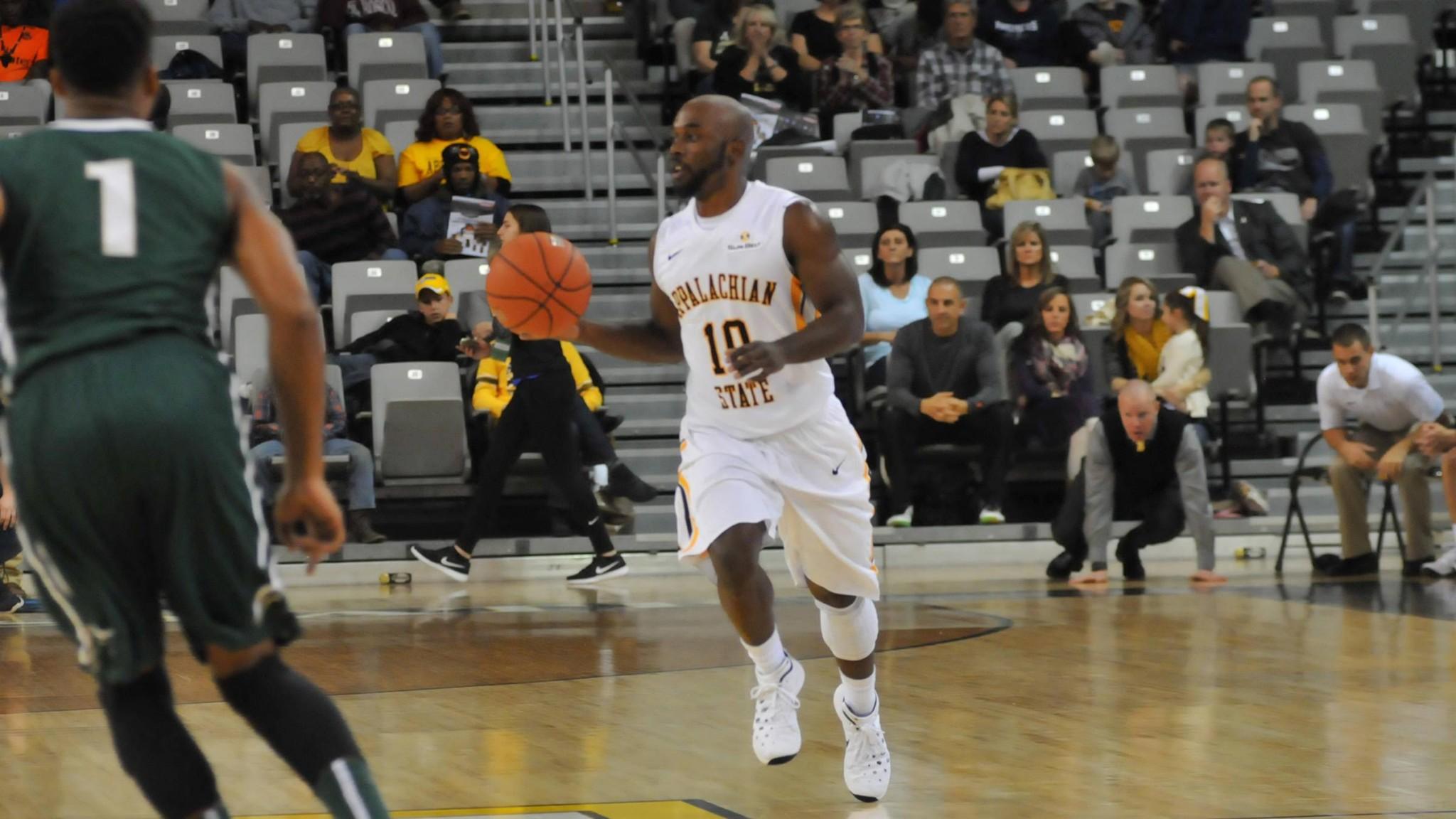 Point guard Chris Burgess takes the ball up-court during Saturday's game against Jacksonville University. The Mountaineers defeated the Dolphin 76-68.  Photo courtesy of Dave Mayo/App State Athletics