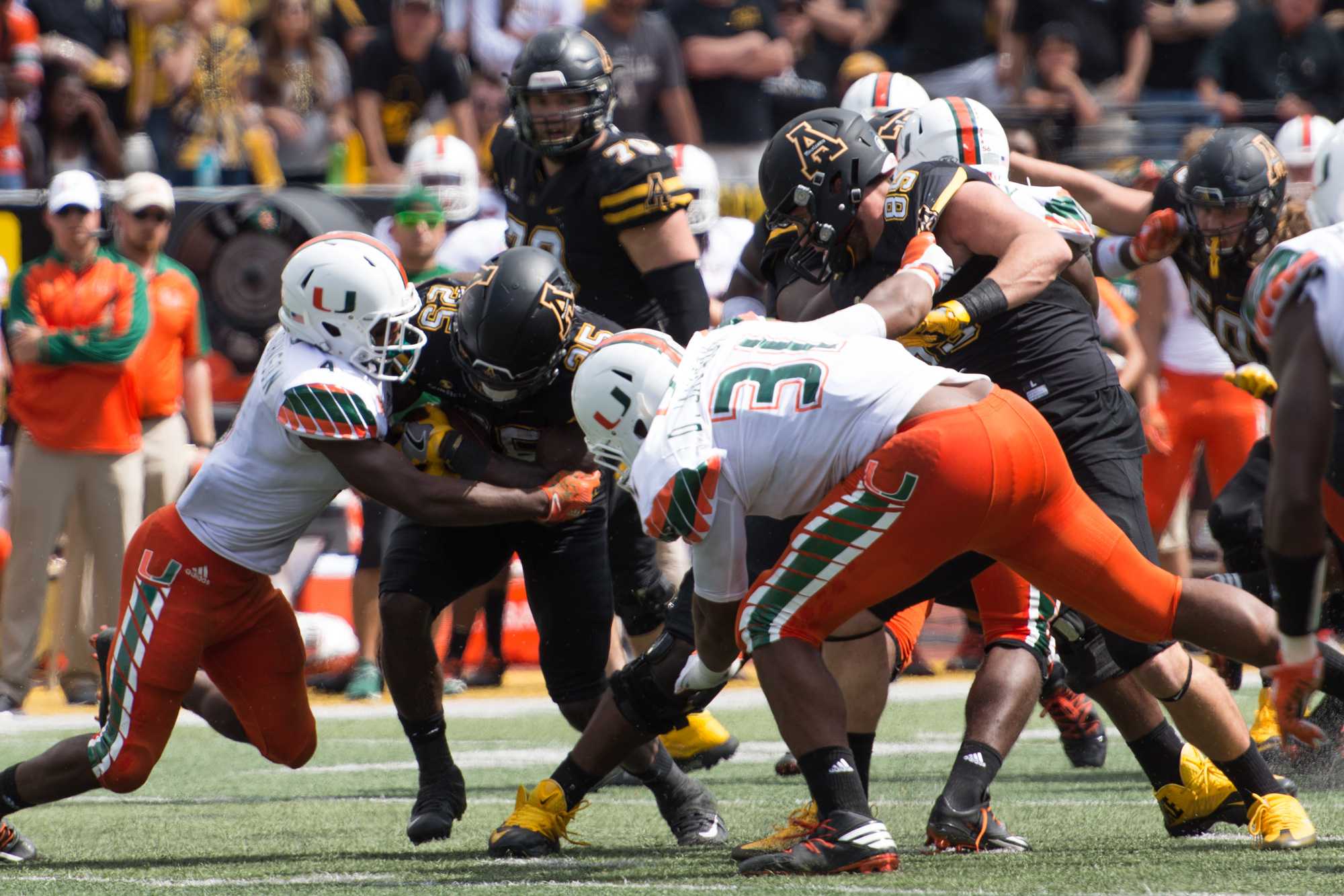 Running+back+Jalin+Moore+attempts+to+break+through+the+Hurricanes+going+for+a+tackle.+Photo+by+Dallas+Linger%2C+Photo+Editor