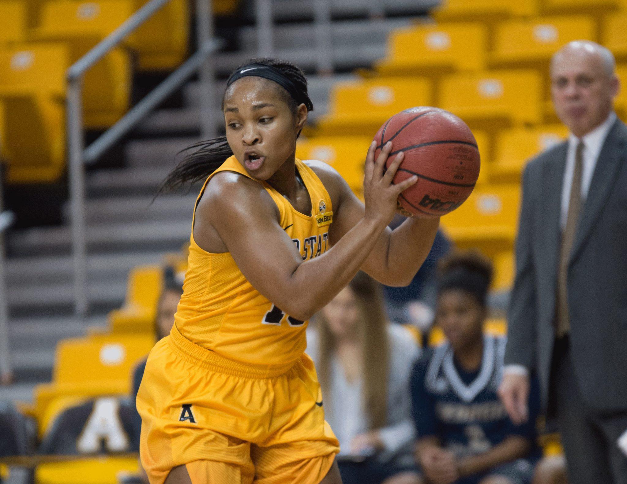 Senior guard Joi Jones, grabs the ball and looks around for an open team mate to pass the ball to. She went 7 for 10 shots and managed to grab 7 rebounds the entire game against Georgia Southern.