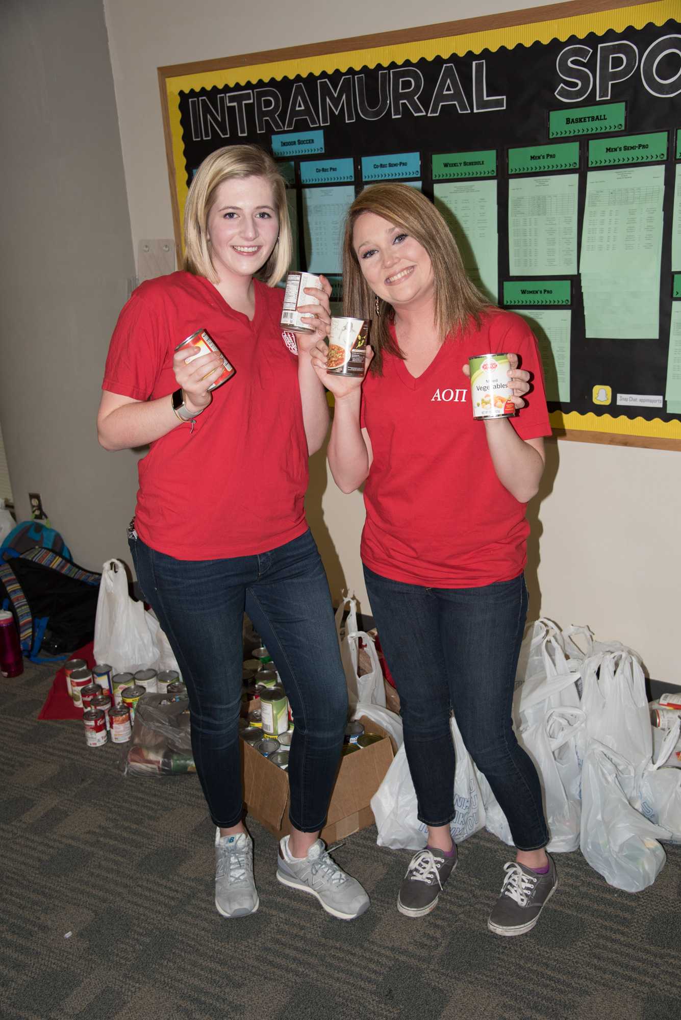 Sophomore+Megan+Dunbar+and+Freshman+Alexa+Bumgarner+at+the+Can+Slam+Basketball+Tournament+in+the+SRC.+Alpha+Omicron+Pi+and+Fiji+hosted+the+basketball+can+drive+to+collect+food+for+the+Hunger+and+Health+Coalition.