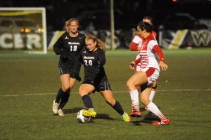 Junior Morgan Mosack dribbles through the defenders. Mosack finished the game with an assist and a shot. Photo Courtesy: App State Athletics/Dave Mayo