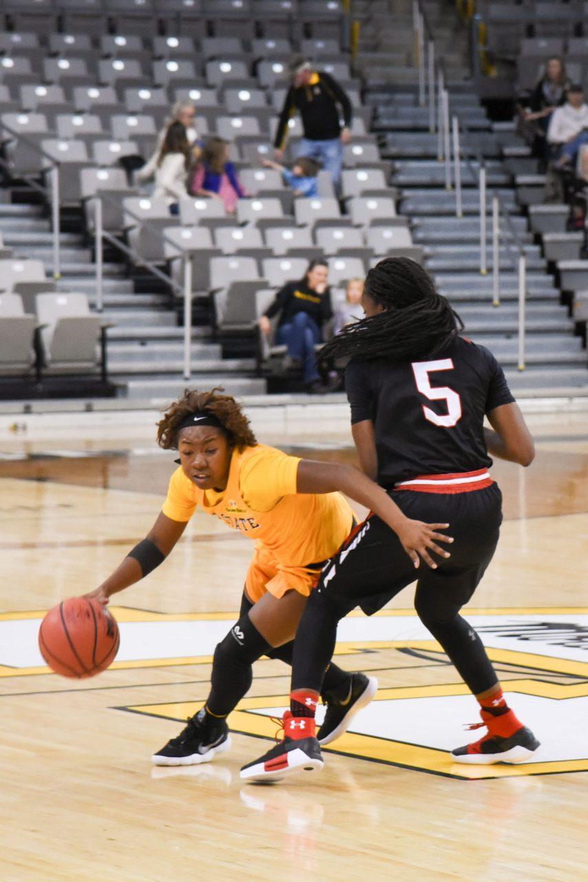 Freshman guard Tierra Wilson makes her way around an opposing Davidson player towards the basket. 