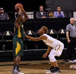 Sophomore guard Emarius Logan in defense against Methodist in their exhibition. 