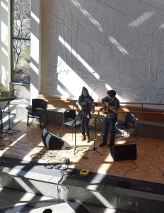 Musicians perform for judges and an audience in the Solarium during the adult fiddle competition.