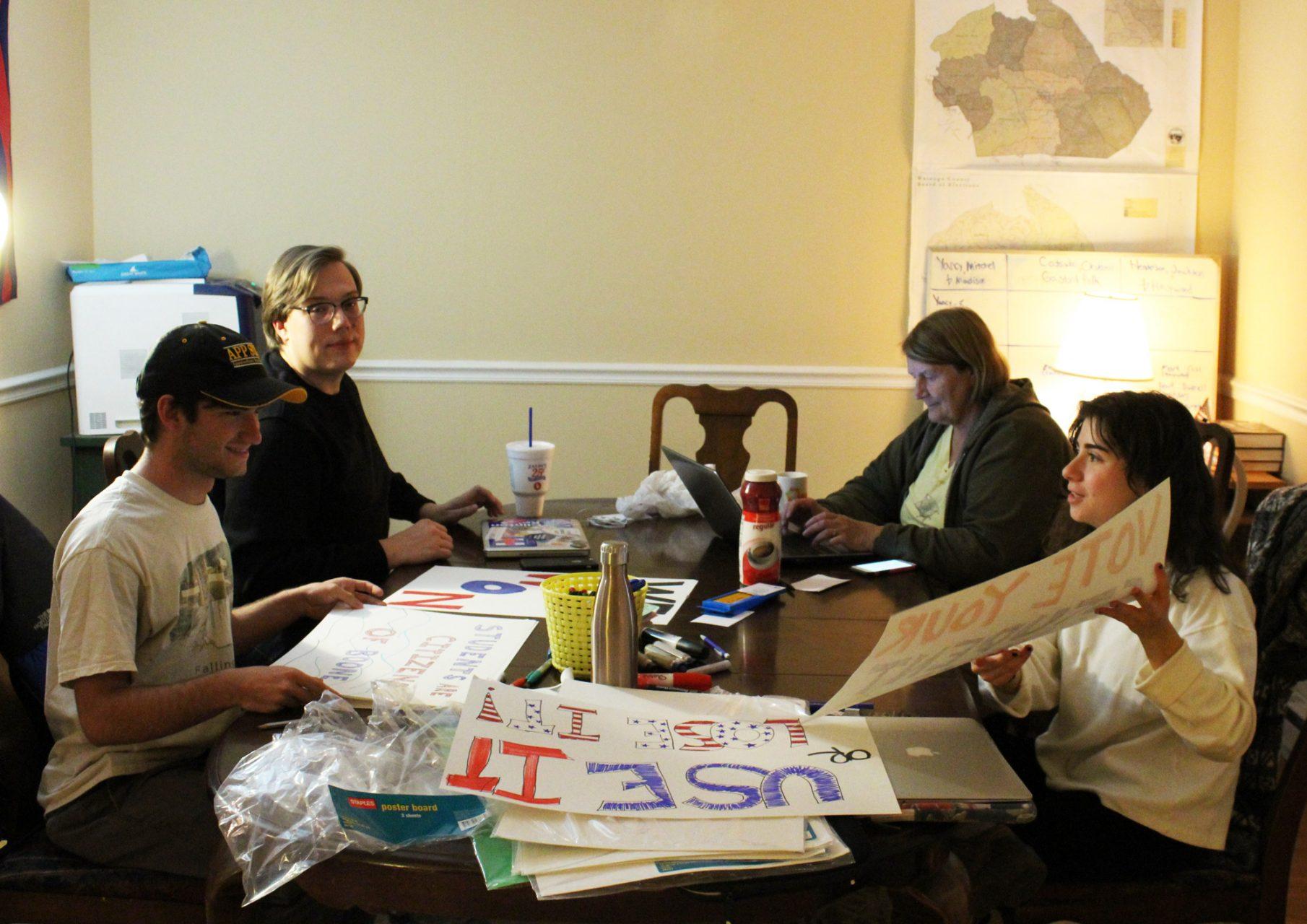 Several members of the Watauga County Democratic Party working on posters for a celebration of the voting site on campus on Oct. 25 at the partys headquarters in downtown Boone. The party spearheaded the lawsuit that secured App State students the right to vote on campus in this years municipal election.