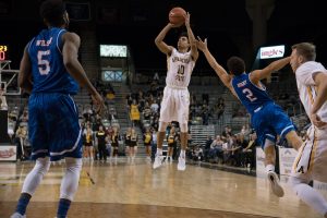 Freshman guard Patrick Good, shoots the ball from the three point line during the game against UTA. Photo by: Halle Keighton, Photo Editor