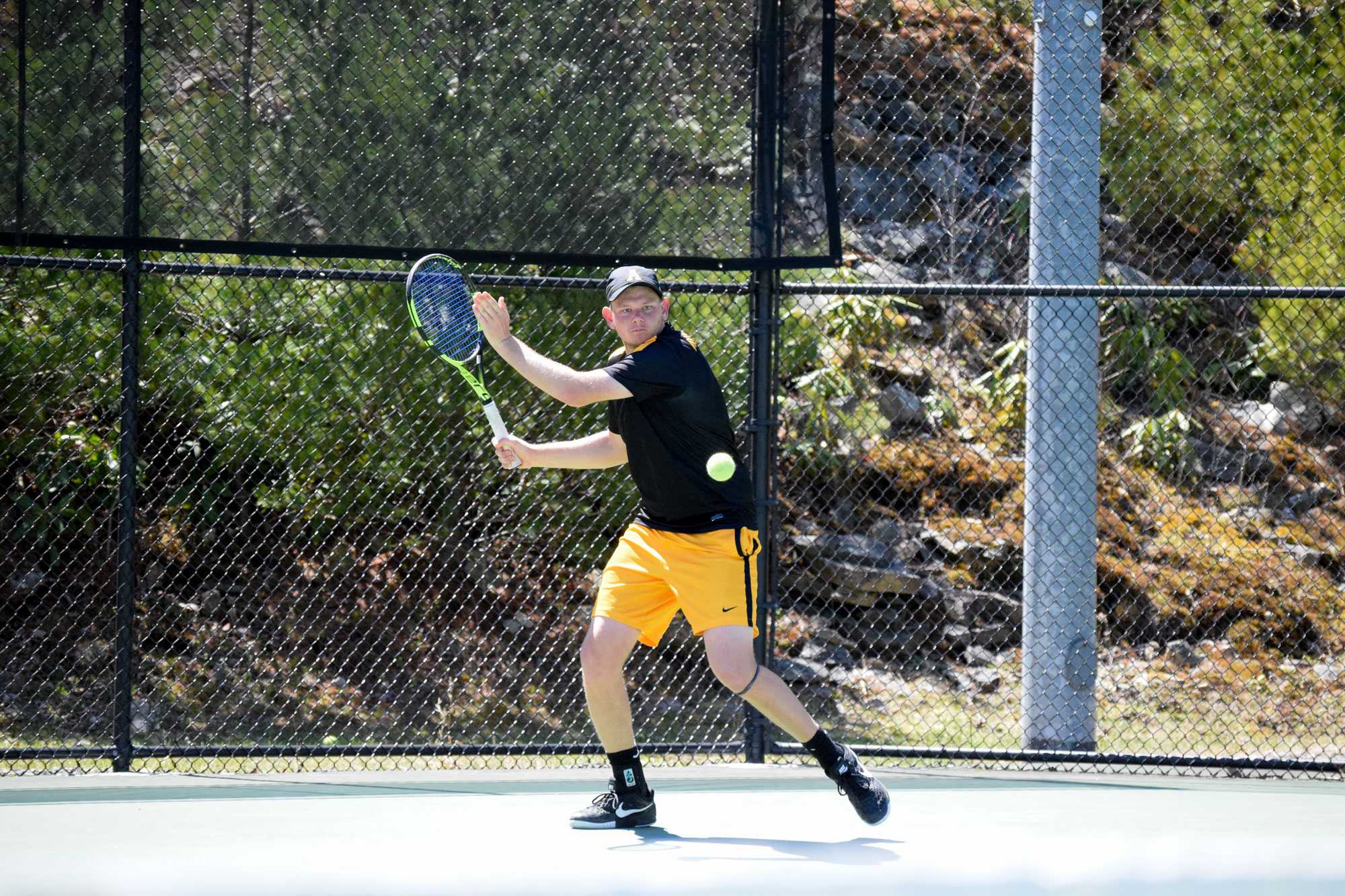 Senior Jack Maddocks hitting the tennis ball to Georgia Southerns Eddie Landin.