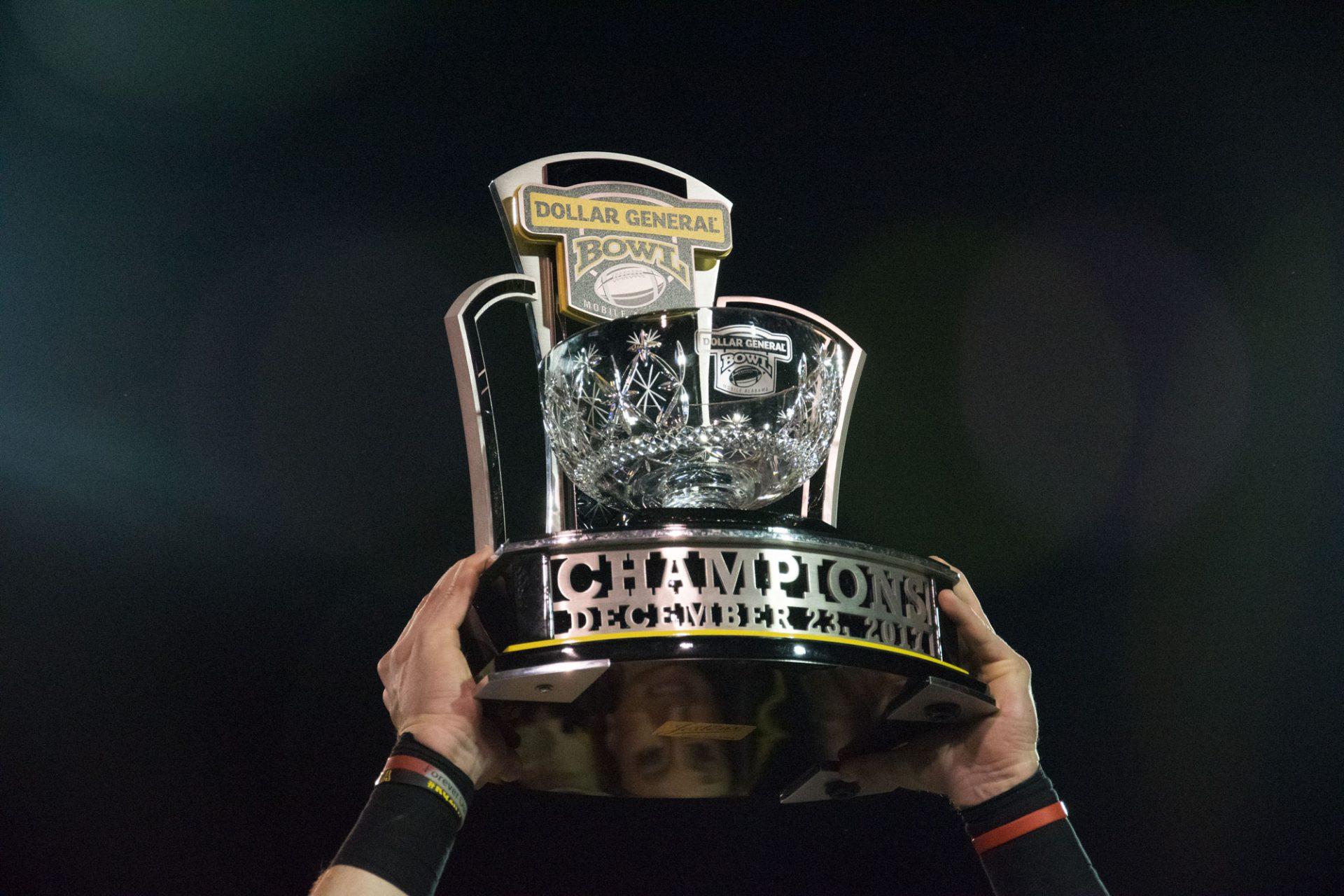 Eric Boggs lifts the Dollar General Bowl trophy during the post-game celebrations on December 23rd in Toledo.