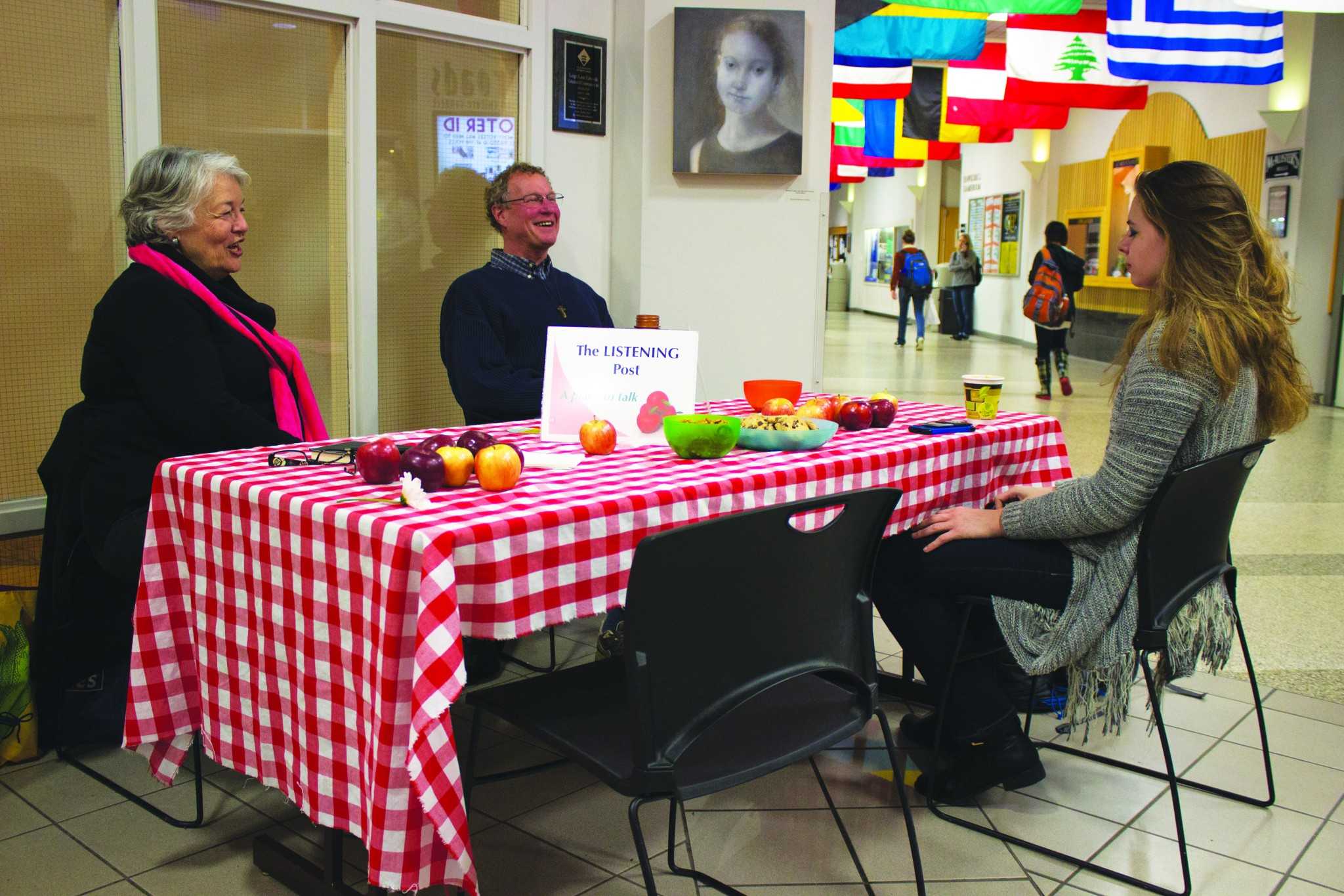 Sophomore Adria West converses with Judy Lilly and Greg Erickson at the Listening Post in the Student Union. Photo by Dallas Linger.