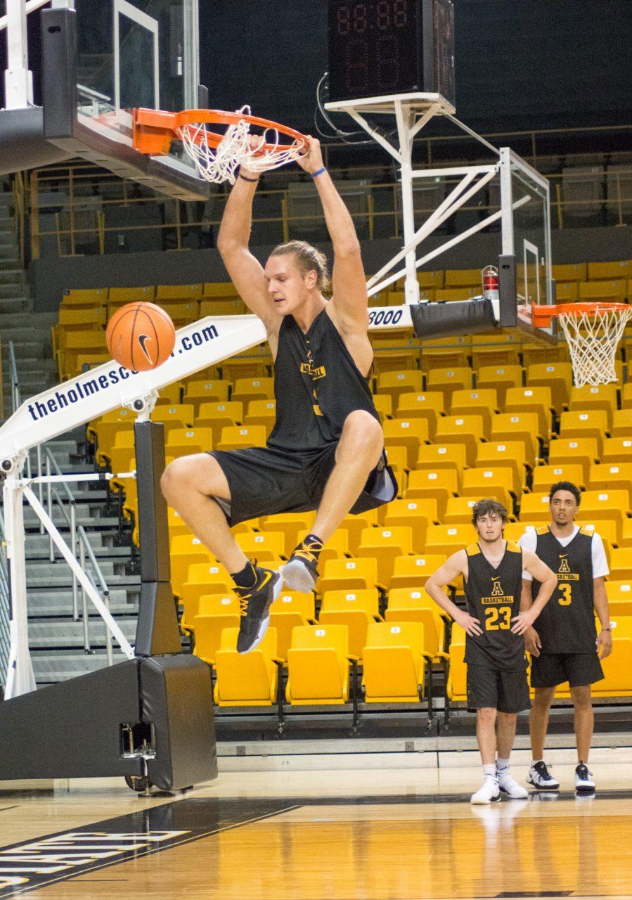 Senior Forward Griffin Kinney dunking the basketball during the Mountaineers first practice of the year. 