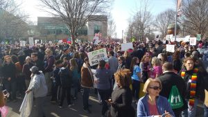 Protestors with signs from the march on Saturday. Signs voiced grievances over reproductive rights, police brutality, healthcare, representation in the state and federal government and other issues.