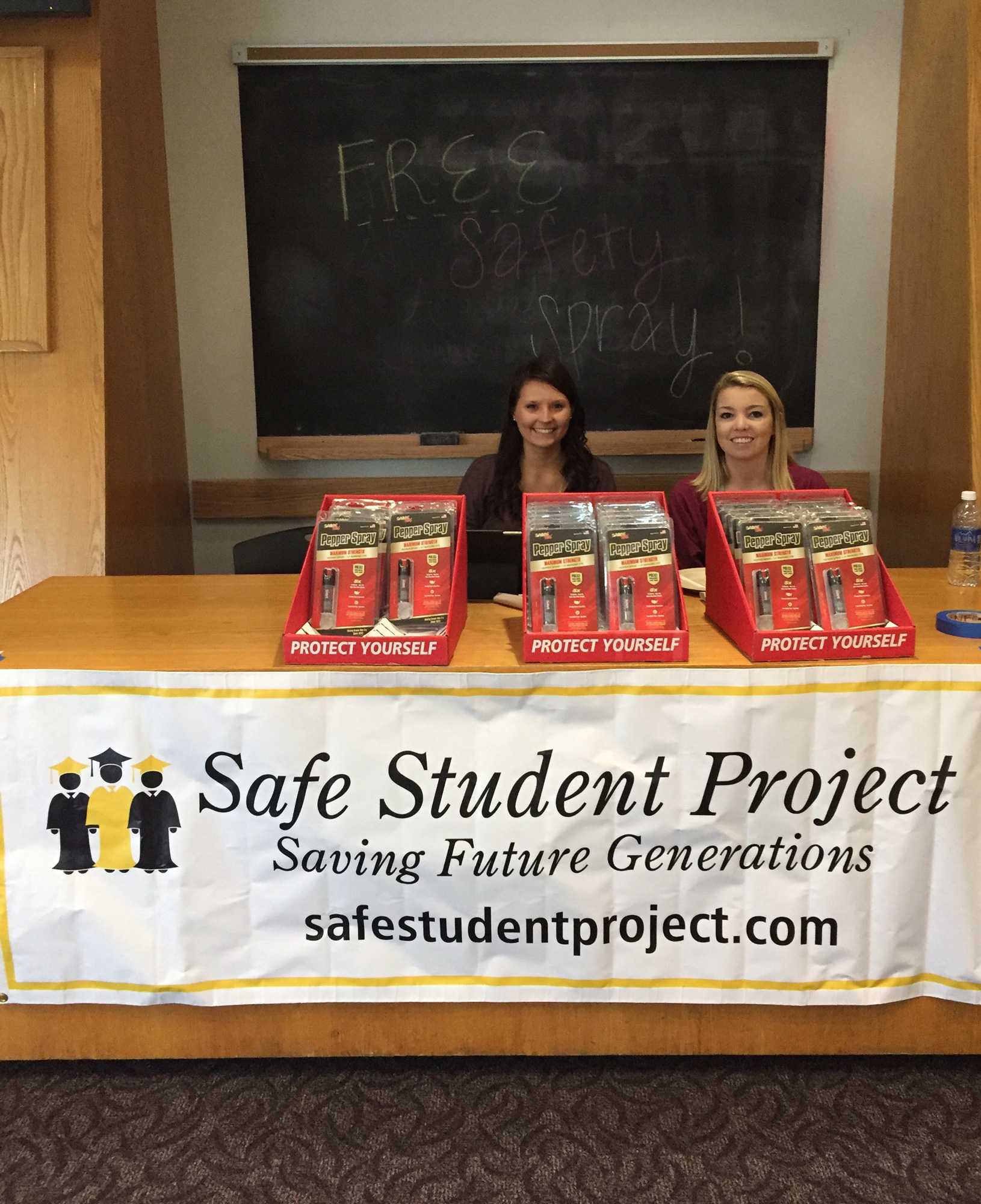 Kristen Howell and Sara Bailey of the Safe Student Project with some of the pepper spray they give out for free at the project’s sessions. They give about out 30-50 units per session and host them at least once a semester. Photo courtesy of Kritsen Howell.