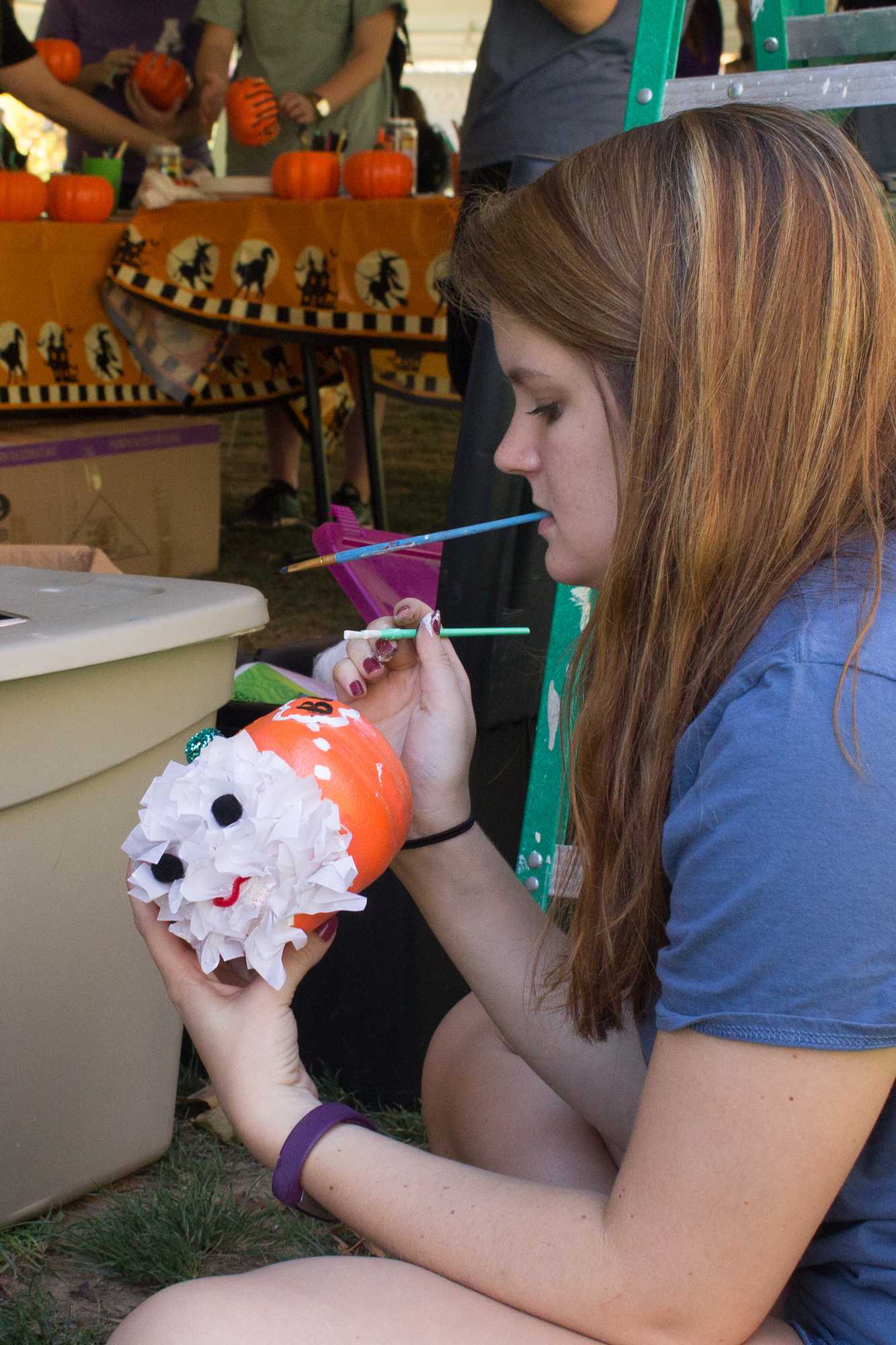Junior management major and APPS executive officer Morgan Nystedt paints a pumpkin for Mountaineer Spirit Day on Oct. 19.