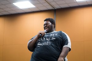Anthony Jennings laughs with his audience during APPS stand-up comedy competition. He performed a second, impromptu routine for a tiebreaker round with Ben Lynch. 