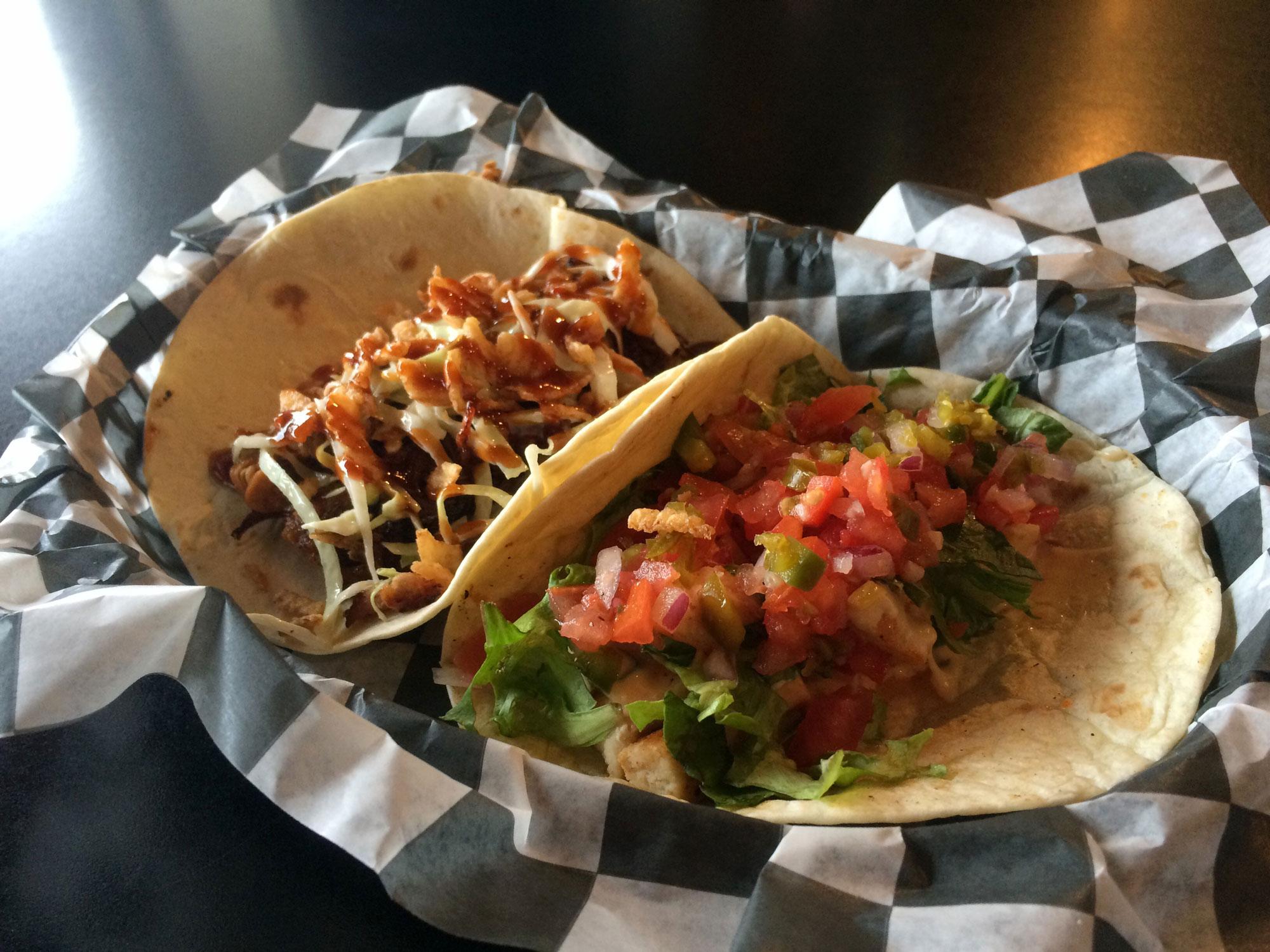 From left to right: TApp Room's barbecue and chicken tacos. The barbecue taco features crispy onion sticks and the chicken tacos are topped with fresh house-made pico de gallo.