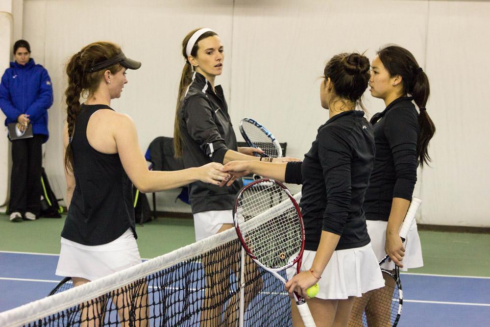 Taylor Bygrave, freshman, and her teammate Mackenzie LaSure, senior shake hands with the Emory Univeristy players after their doubles competition on Saturday, February 27th. The game resulted in App State losing 7-2 in a tie breaker match. Photo by Halle Keighton.