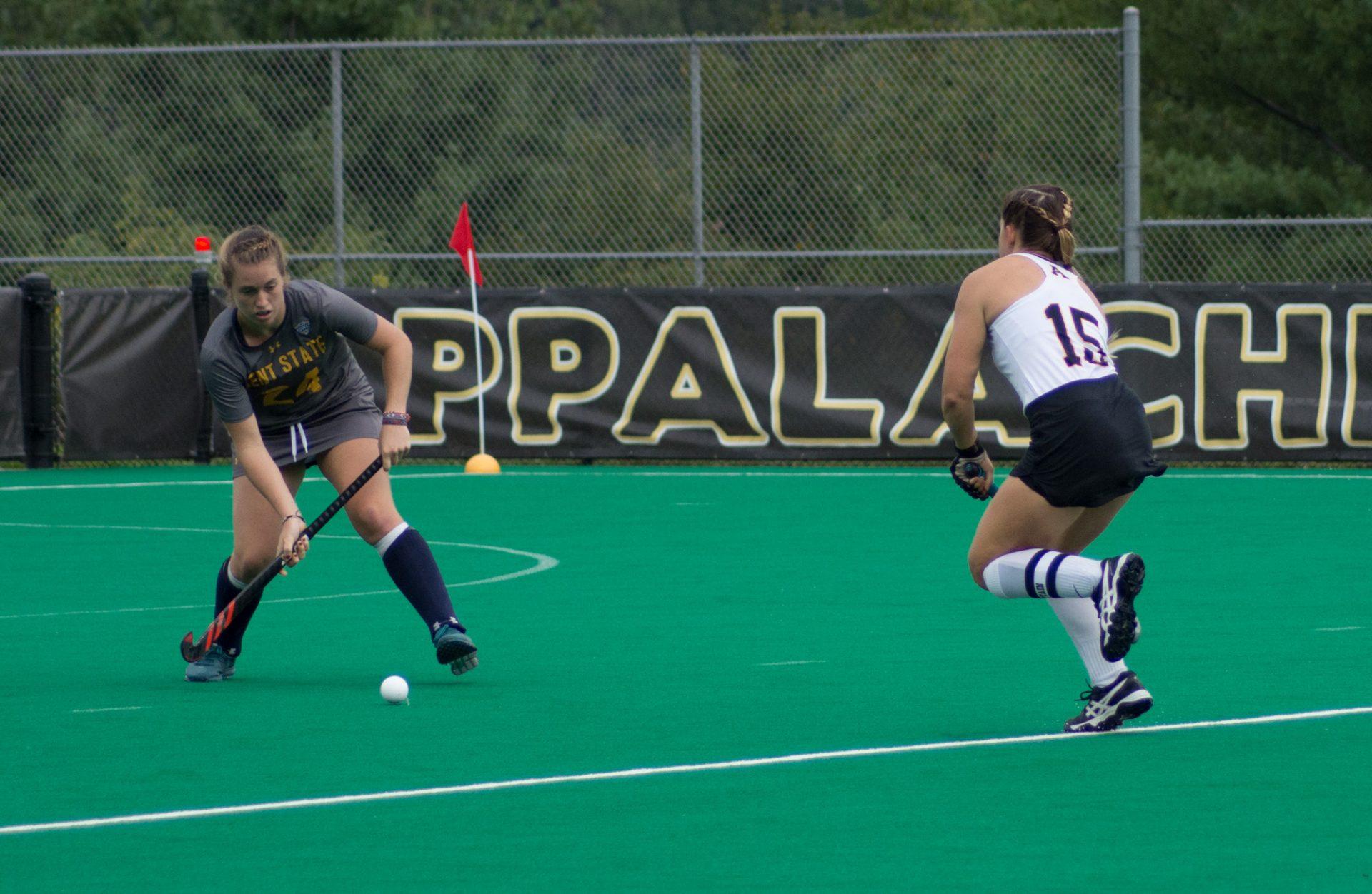 Midfielder Taylor Cimbalist defending a pass from a Kent State player. 