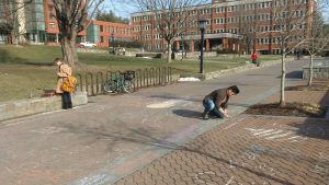 Andrew Mullins, a freshman psychology major, chalking at the Appalachian State Young Americans for Liberty Chalking for Free Speech event. The event was held to protest the university's chalking policy.