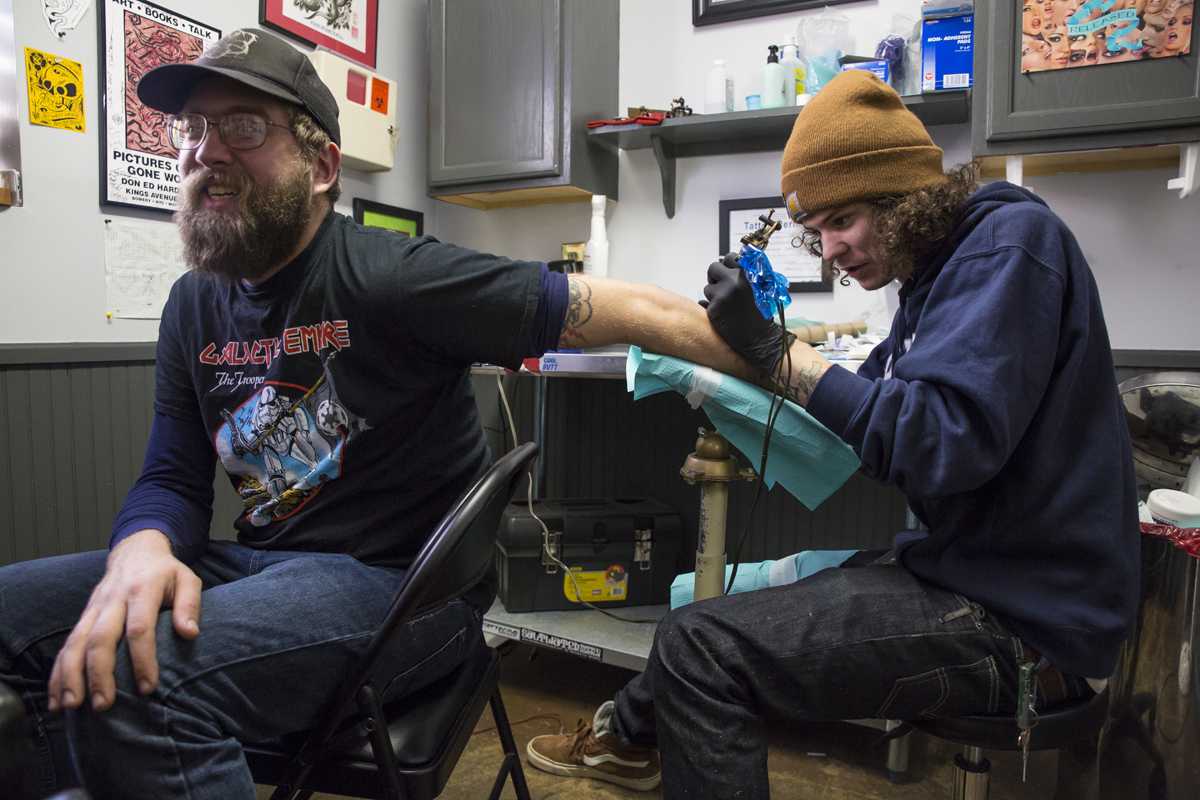 Tattoo artist Justin Norton applies ink to a tattoo on 

Jason Korff at Speakeasy Tattoo Company on Feb 30. Photo by Chris Deverell.