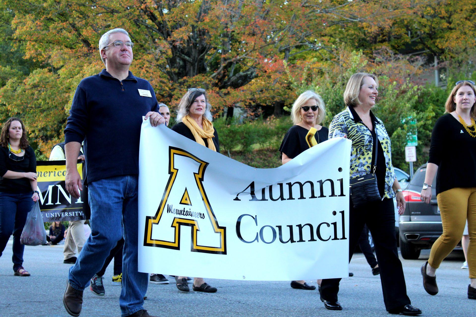 ASUs Alumni Council walking in the 2017 homecoming parade on Friday in downtown Boone.