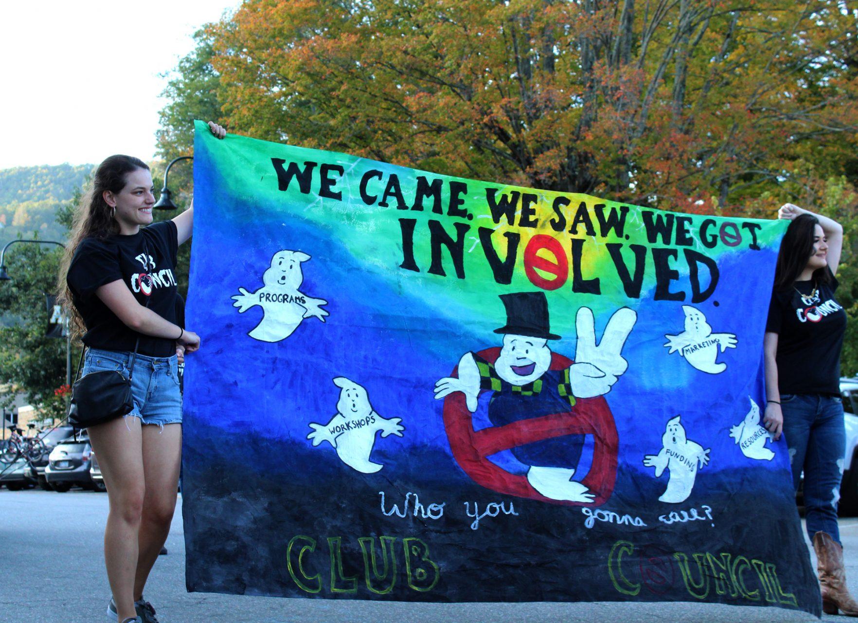 ASUs Club Council holding their banner during Fridays homecoming parade.