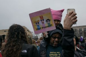 A family taking a selfie before the Women’s March begins. The march was on January 21st, the day after the inauguration of President Donald Trump 