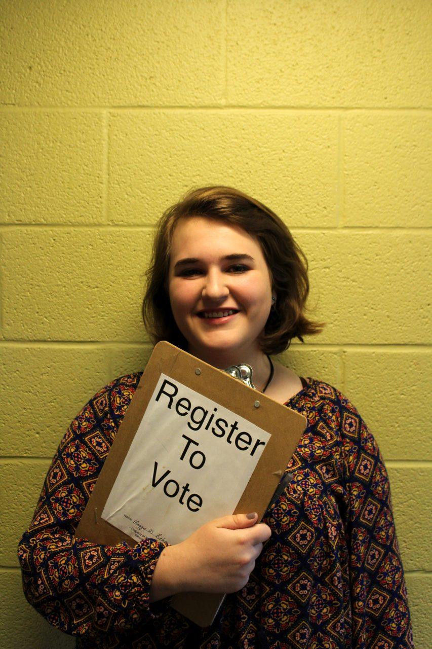 Freshman Maggie Behm posing with her voter registration clipboard. Behm is an intern for the North Carolina Democratic party and dedicates her time to registering students to vote in Boone.