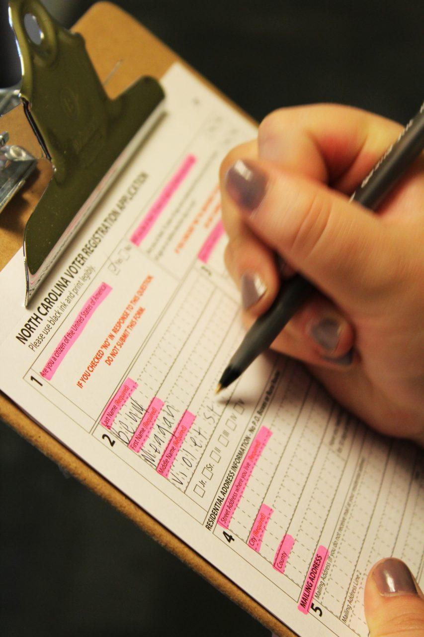 Freshman Maggie Behm demonstrating how to fill out a voter registration form. Behm has been apart of several on-campus initiatives to encourage Appalachian students to vote.