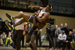 App State’s Randall Diabe takes the Moc’s Clay Dent to the mat to prevent an escape. 