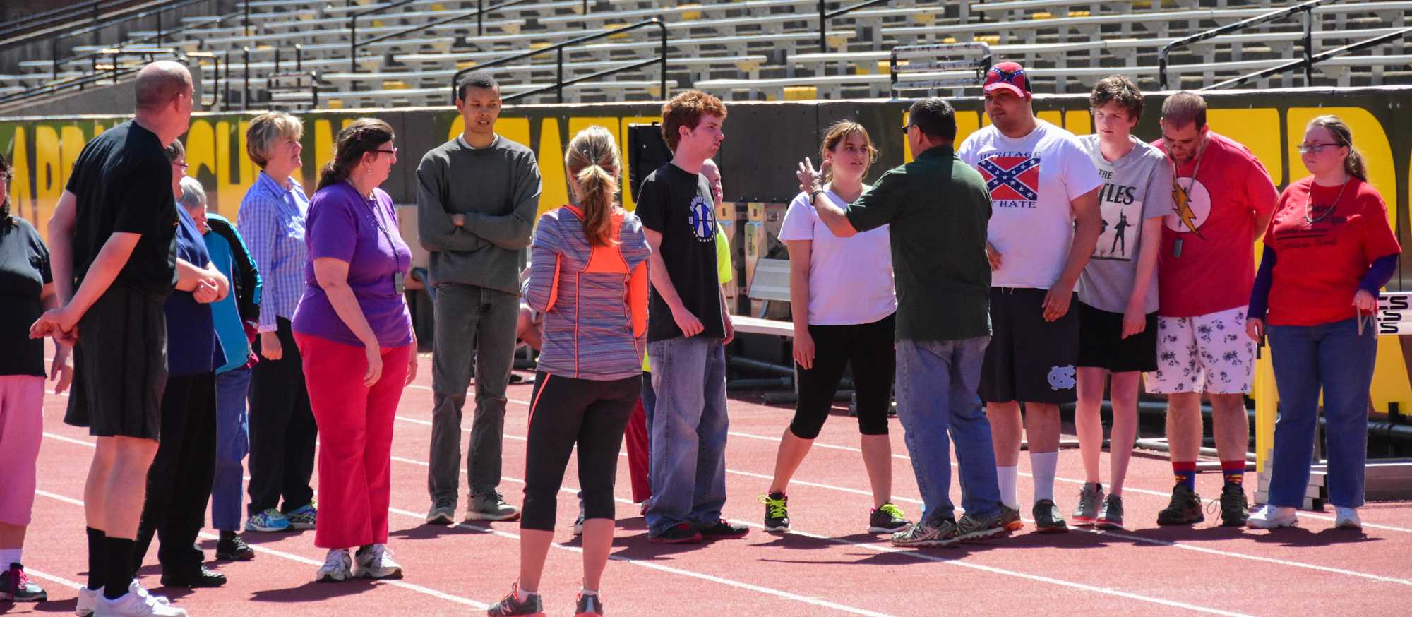 Keron Poteat instructs the Olympians in properly doing the walking and running races. Photo by Lee Sanderlin.