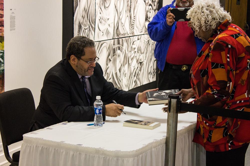 Dr. Michael Eric Dyson signs books after his talk commemorating Martin Luther King Jr. on Tuesday, April 12th in the Schaefer Center. Dyson is a professor of sociology at Georgetown Universty and a best-sellling author. Photo by Halle Keighton.