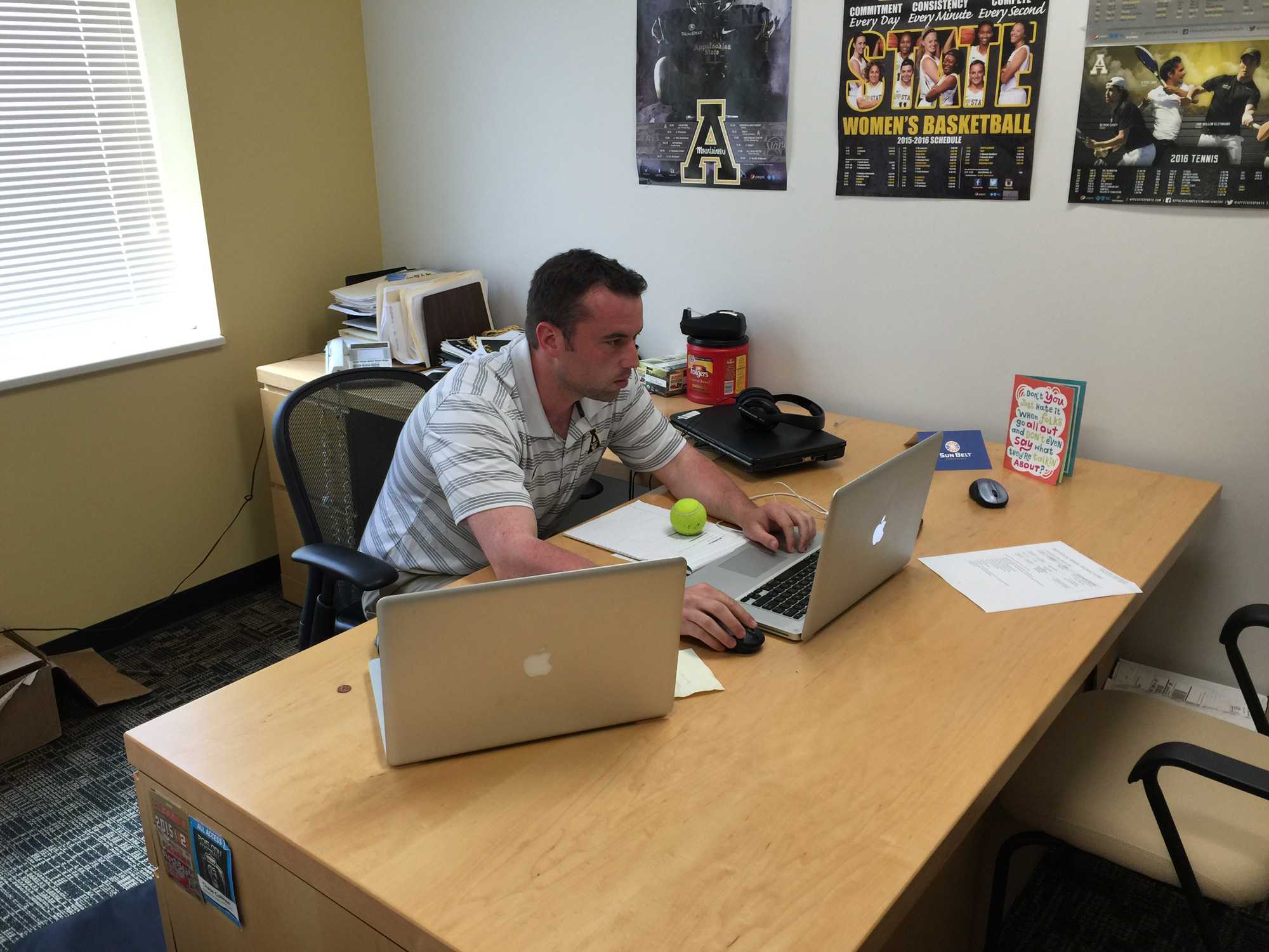 Assistant Sports Information Director Chase Colliton in his office.