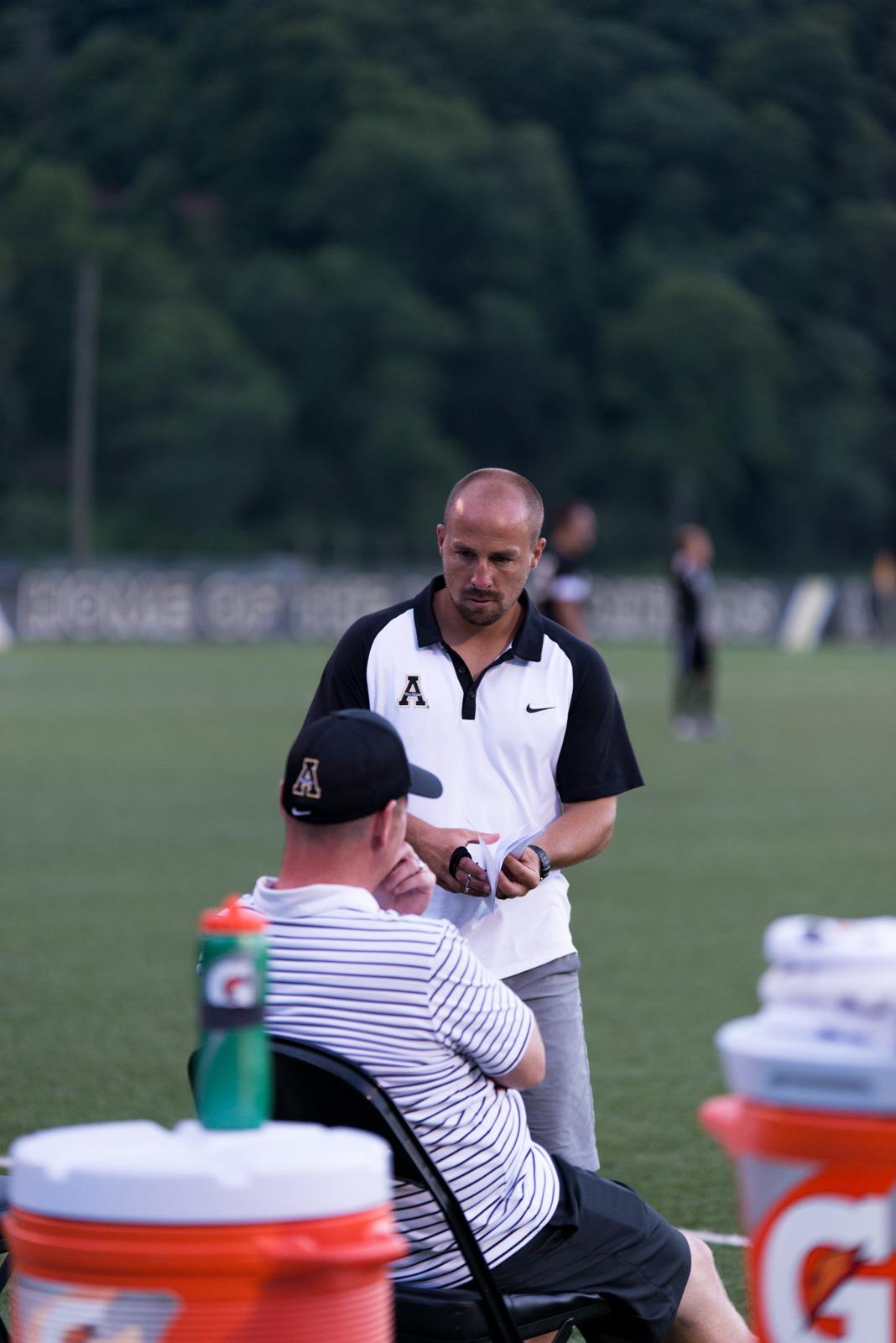 Assistant Coach Jeff Bilyk and Head Coach Jason OKeefe strategizing during the exhibition on Friday at Ted Mackorell Soccer Complex.