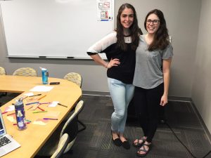 Two officers of the club, Junior Andrea Santoyo and senior Emily Bradley. The club meets every Monday at 6:15 pm and they use tangible acts of love to lift people's moods and empower individuals.