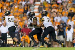 Taylor Lamb hands the ball off to Marcus Cox at Tennessee last week. Cox ran for 115 yards in the game with one receiving touchdown. Photo by Dallas Linger