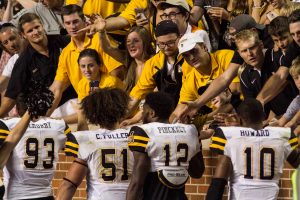 Defensive end Caleb Fuller and cornerbacks Brandon Pinckney and AJ Howard high five the fans in Knoxville. Photo by Halle Keighton