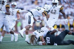 Duck goes to secure a tackle with junior outside linebacker Devan Stringer against Old Dominion last Saturday.